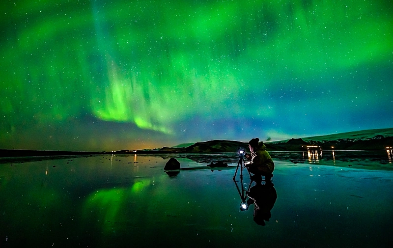 The Northern Lights dancing in the sky.