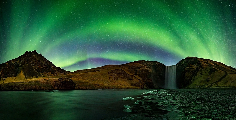 Northern Lights at Skogafoss waterfall in Iceland